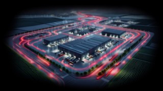 Your performance is our focus! Eine Logistikhalle in der Nacht, rote Lichter zeigen die Wege der Fahrzeuge